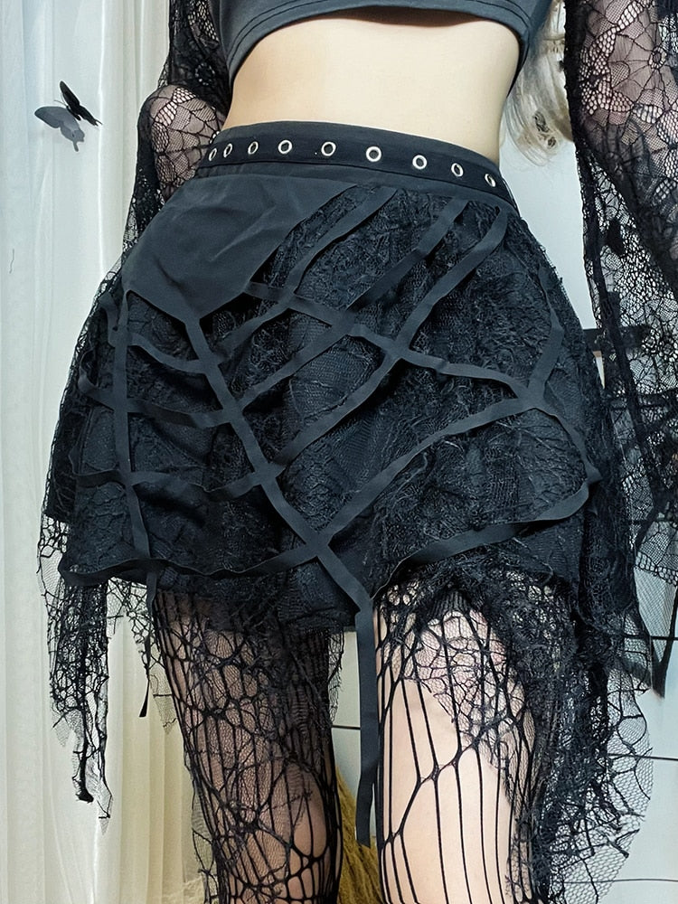 Web Of Darkness Mini Skirt. This sheer skirt has a spider web design on the front, spider web mesh construction, handkerchief hem and an elastic waist with front eyelet details.
