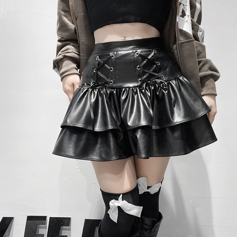I'm In Control Mini Skirt. This layered mini skirt has a vegan leather construction with front lace ups design, back zip closure and a high waist fit.
