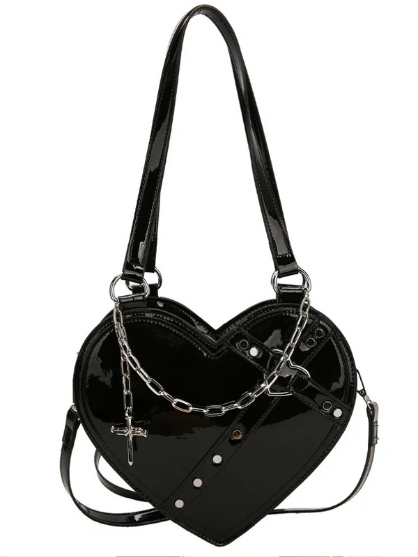 Achy Breaky Heart Bag. This bag comes in a vinyl construction, in a heart shape with a draped chain with cross pendant, silver studded hardware, zip closure and adjustable shoulder crossbody strap.