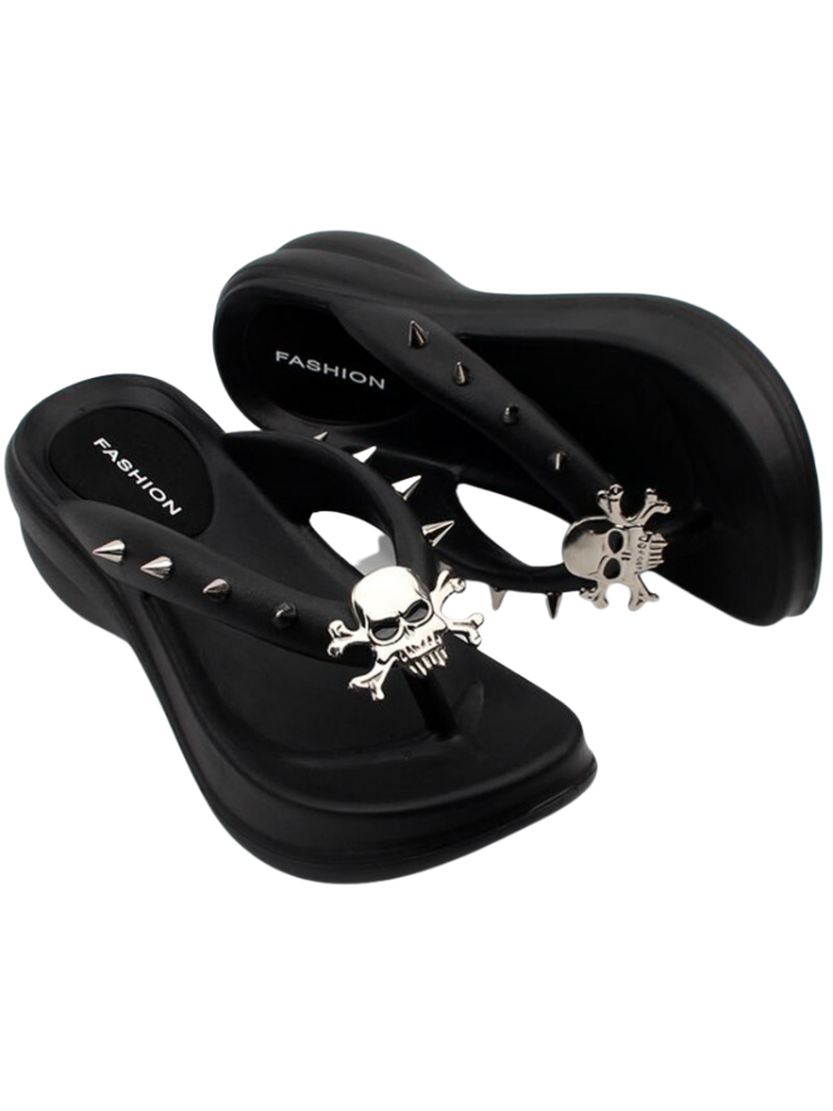Hell To Raise Skull Platform Slides. These platform slides have a rubber construction, a thong straps with decorative spikes and skull head charms.