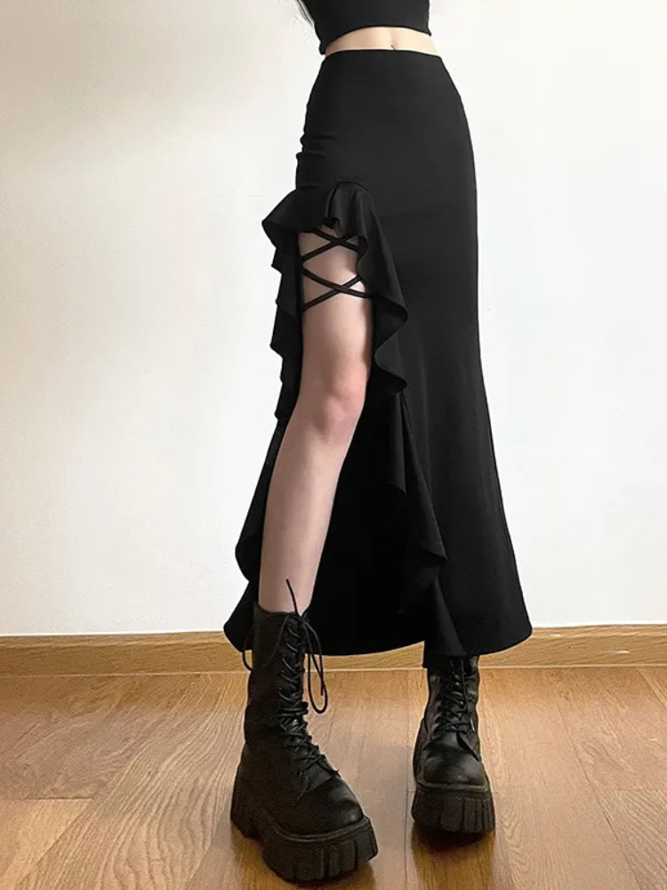 Waiting For The Night Midi Skirt. This midi skirt has a side slit with ruffled detailing, strappy thigh strappy design and a high waist fit.