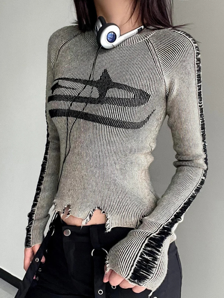 Darkest Star Distressed Knit Top. This top has a knit construction, long sleeves, front star graphic design, distressed hems and a cropped fit.