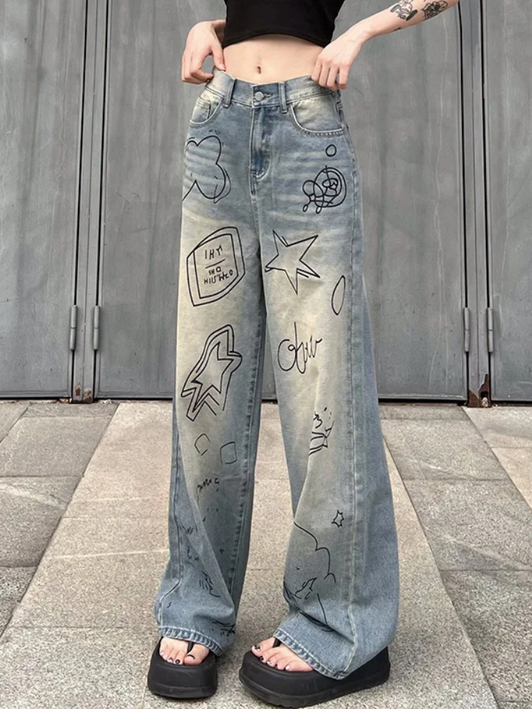 Express Yourself Graphic Jeans. These wide leg denim jeans have low waist fit, doodle graphics on the front and a buttoned zip closure.