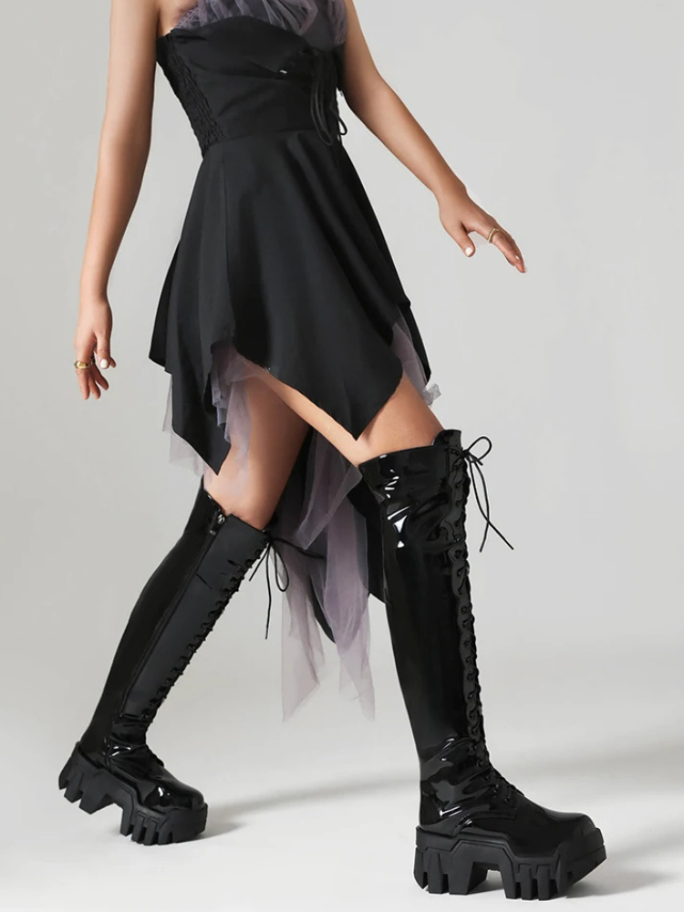 Rebel Core Knee High Platform Boots. These knee high boots have a patnet vegan leather construction, front lace up closure and inner zip closure and rubber treaded soles.