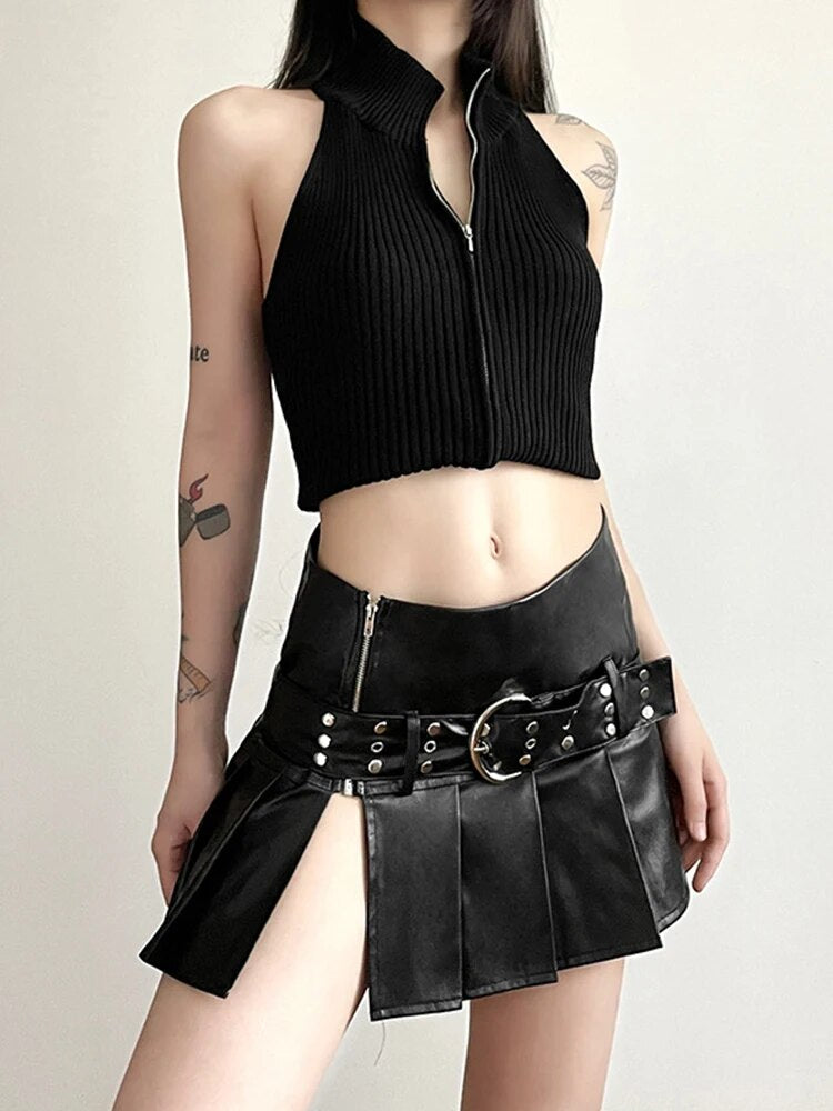 Nighttime Slay Mini Skirt. This pleated mini skirt has a vegan leather construction, a buckled belt, a low rise fit, a side slit and a side zip closure.