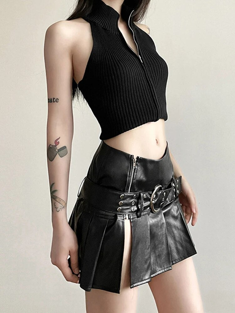 Nighttime Slay Mini Skirt. This pleated mini skirt has a vegan leather construction, a buckled belt, a low rise fit, a side slit and a side zip closure.