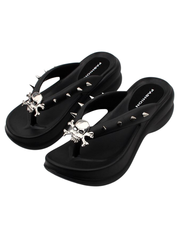 Hell To Raise Skull Platform Slides. These platform slides have a rubber construction, a thong straps with decorative spikes and skull head charms.