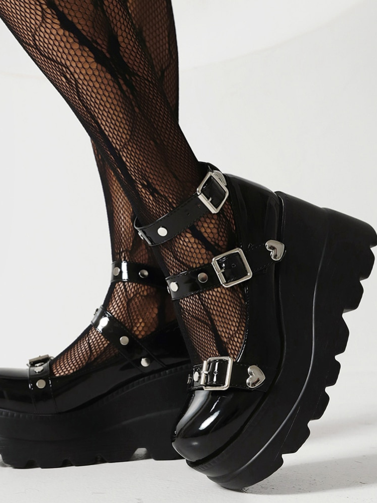 Stomping Hearts Platform Mary Janes. These platform shoes have a patent vegan leather construction, a Mary Jane-style silhouette, adjustable buckled straps with grommets and treaded soles.