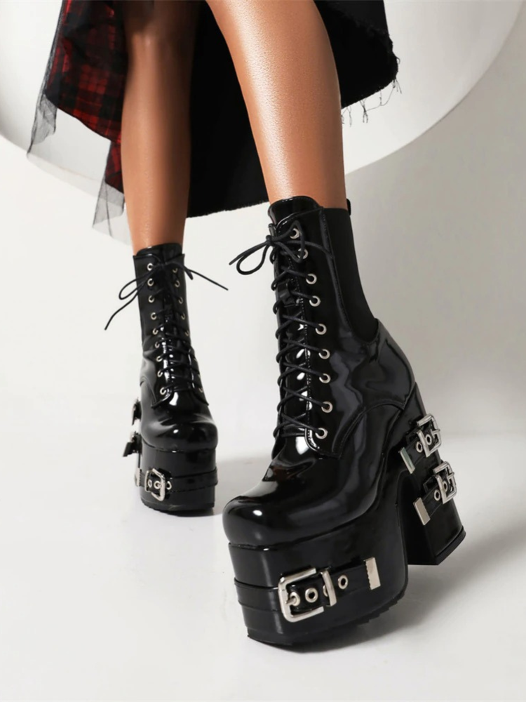 Bad Influence Platform Boots. These massive platform boots have a patent vegan leather construction, chunky block heels with buckle straps accents, front lace up closures and elastic side gussets.