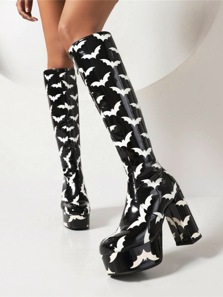 Bat Behavior Knee High Boots. These knee high boots have a patent vegan leather construction with bat print all over, platform soles with chunky block heels and side zip closures.