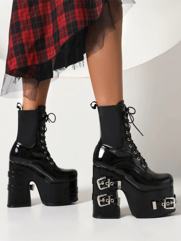 Bad Influence Platform Boots. These massive platform boots have a patent vegan leather construction, chunky block heels with buckle straps accents, front lace up closures and elastic side gussets.