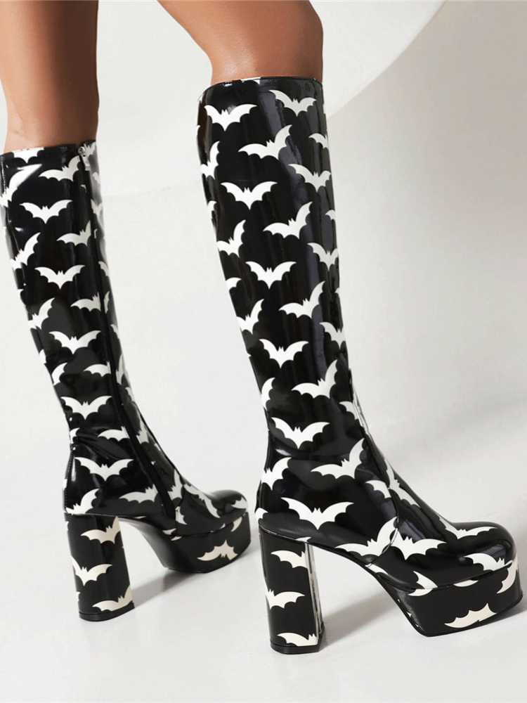 Bat Behavior Knee High Boots. These knee high boots have a patent vegan leather construction with bat print all over, platform soles with chunky block heels and side zip closures.