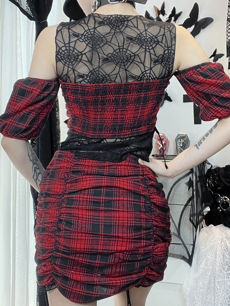 Witchcraft Class Plaid Set. This 3 piece set has a plaid short puff sleeves top with a spider pendant and ruched sides with ties, plaid mini skirt with ruched sides and a web mesh trim and a matching web mesh tank top underneath.