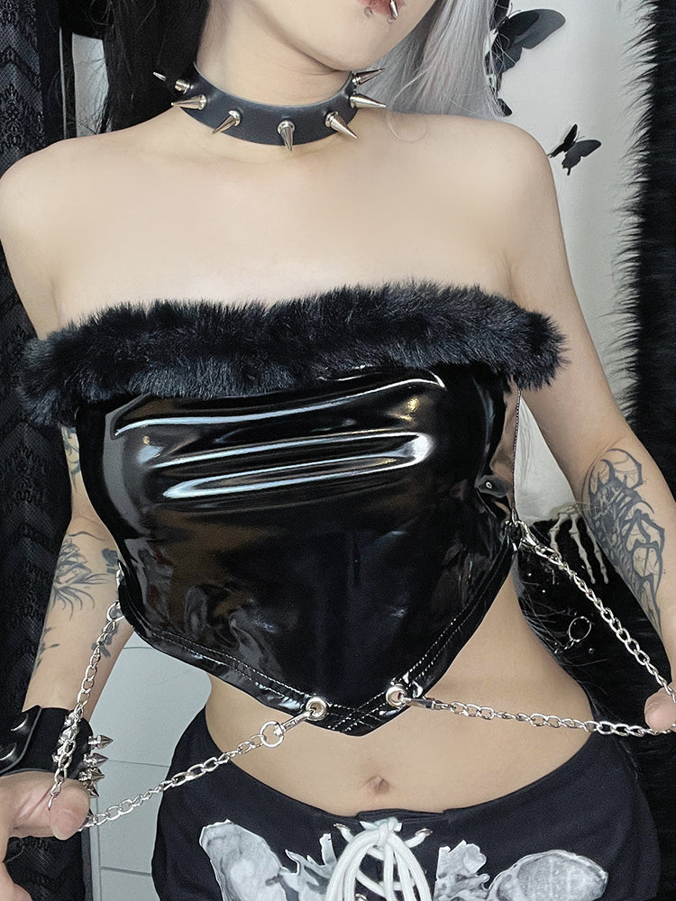 Wicked Night Tube Top. This strapless tube top has a patent material, faux fur trim at the bust, V shaped hem with hanging chains and a back zip closure.