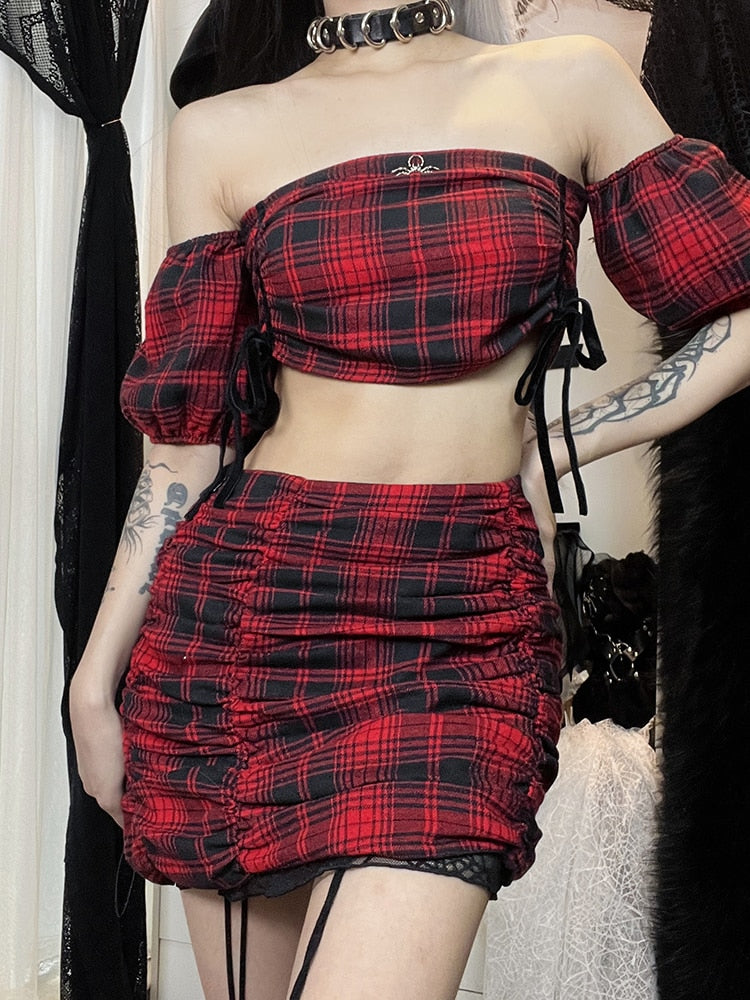Witchcraft Class Plaid Set. This 3 piece set has a plaid short puff sleeves top with a spider pendant and ruched sides with ties, plaid mini skirt with ruched sides and a web mesh trim and a matching web mesh tank top underneath.