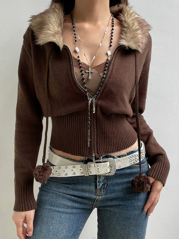 Wild Forever Knit Jacket comes in a knit construction, with a front zipper closure, a faux fur collar, drawstrings with pom poms and a cropped fit.