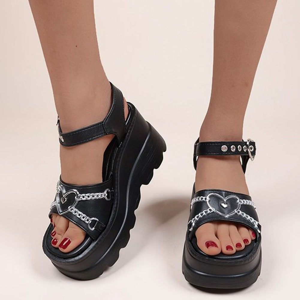 Loving Revelation Platform Sandals. These platform sandals features a vegan leather construction, a cute heart-shaped hardware and an adjustable ankle strap heart-shaped buckle closure.