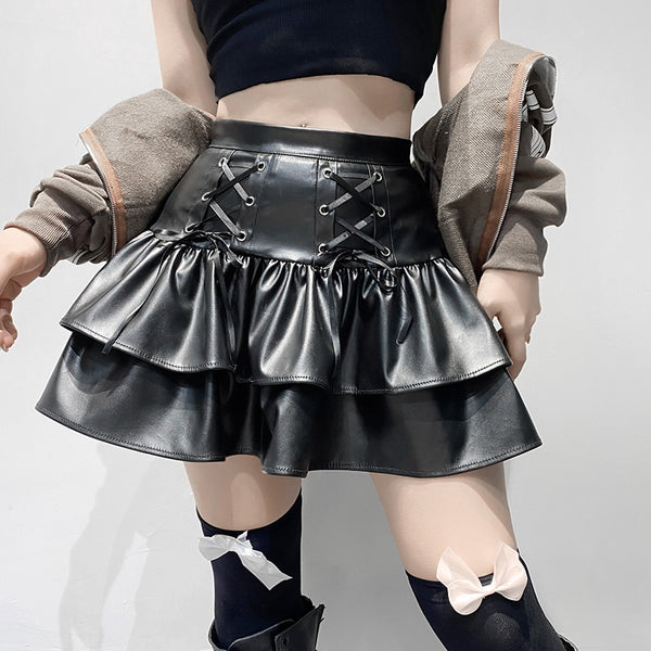 I'm In Control Mini Skirt. This layered mini skirt has a vegan leather construction with front lace ups design, back zip closure and a high waist fit.