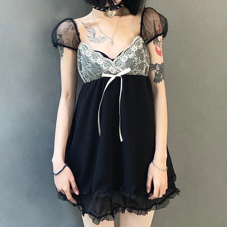 Endless Romance Mini Dress. This totally adorable mini dress has short mesh puff sleeves, lace overlay with a bow on the chest and a sweetheart neckline and a ruffle trim.